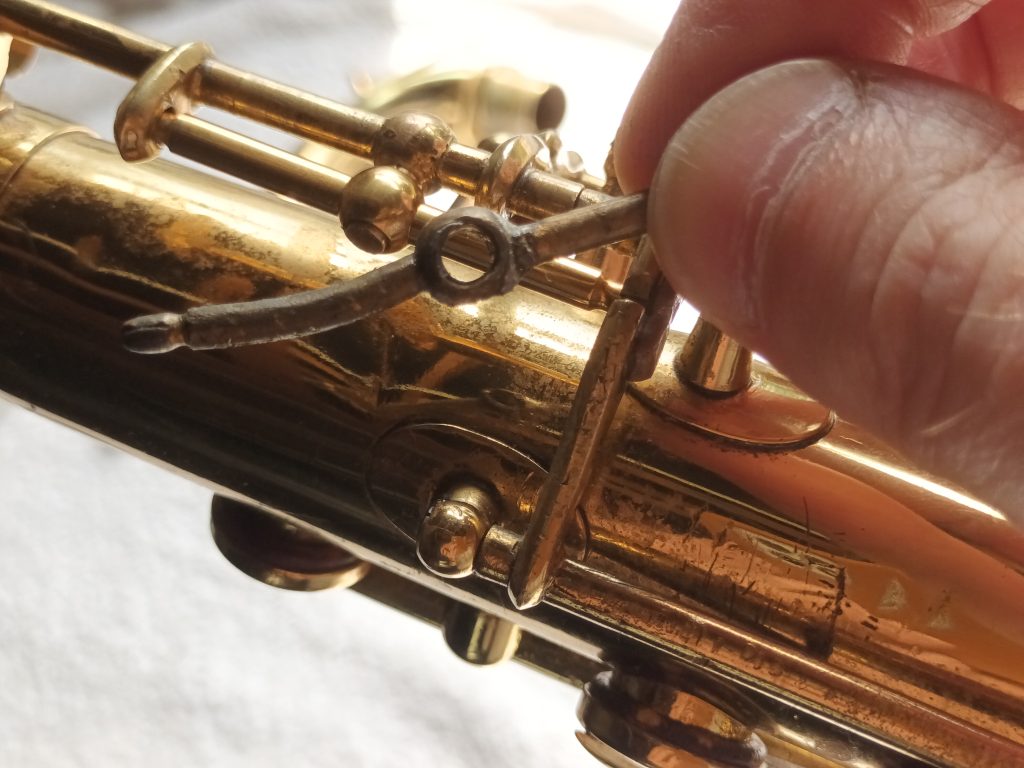 A mishapen and bent saxophone octave key rocker