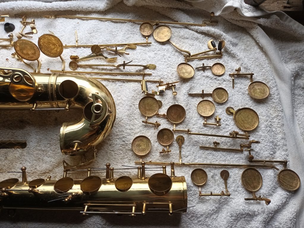 Jumble of saxophone parts missing their pads Saxophone keys with the pads removed