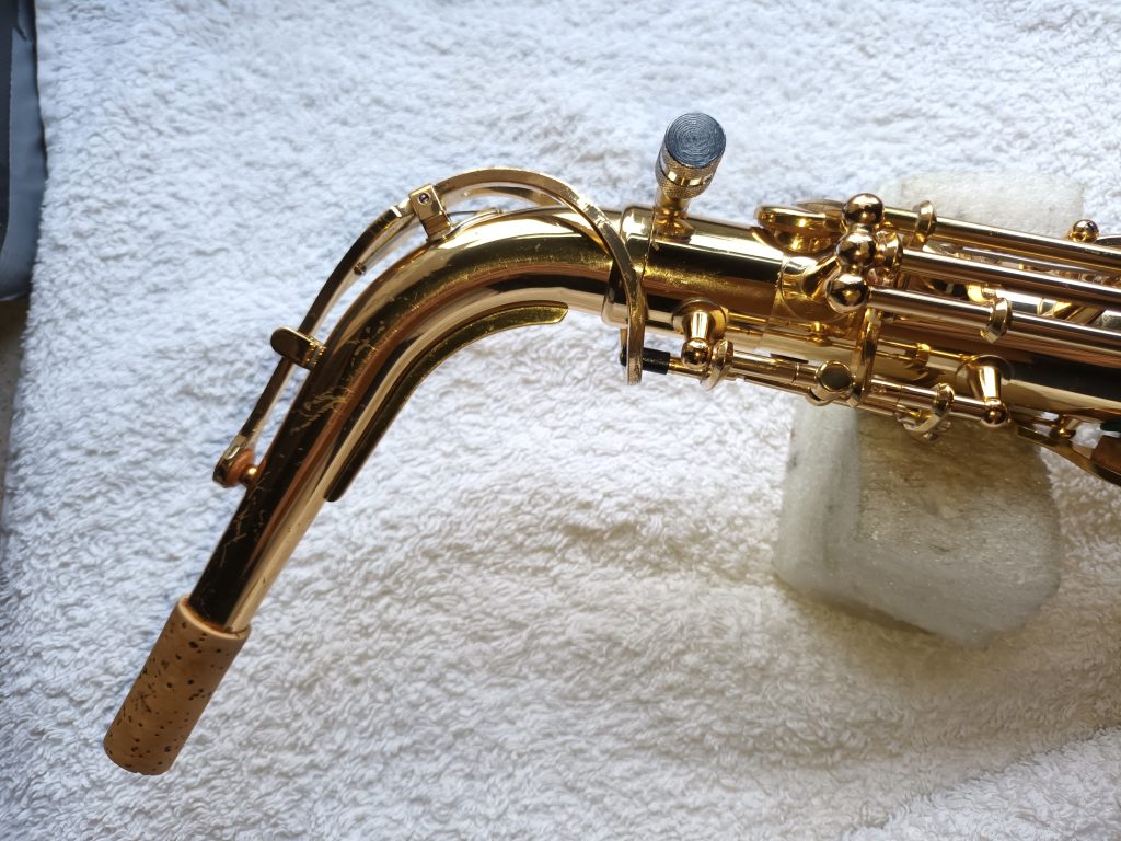 Saxophone neck inserted into saxophone A well fitted saxophone neck and screw